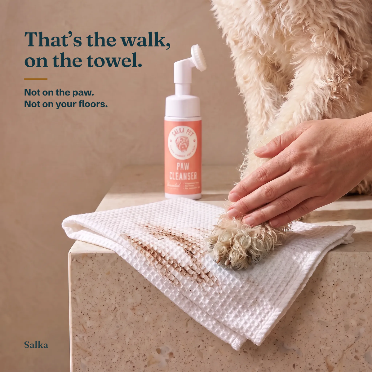 Dirt wiped onto a towel after cleaning a dog's paw with SalkaPet rinse-free paw cleanser