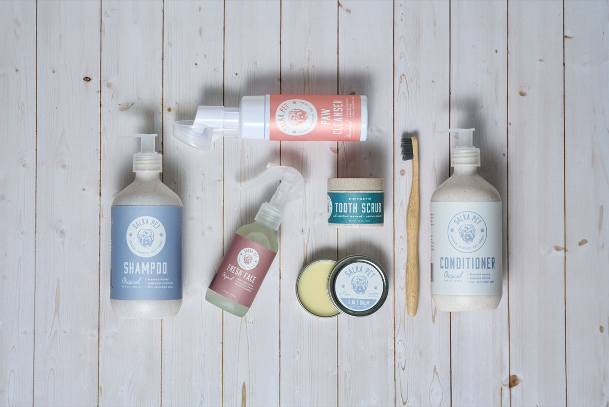 The full SalkaPet dog grooming lineup — shampoo, conditioner, paw cleanser, tooth scrub, 3-in-1 balm, fresh face, and bamboo toothbrush